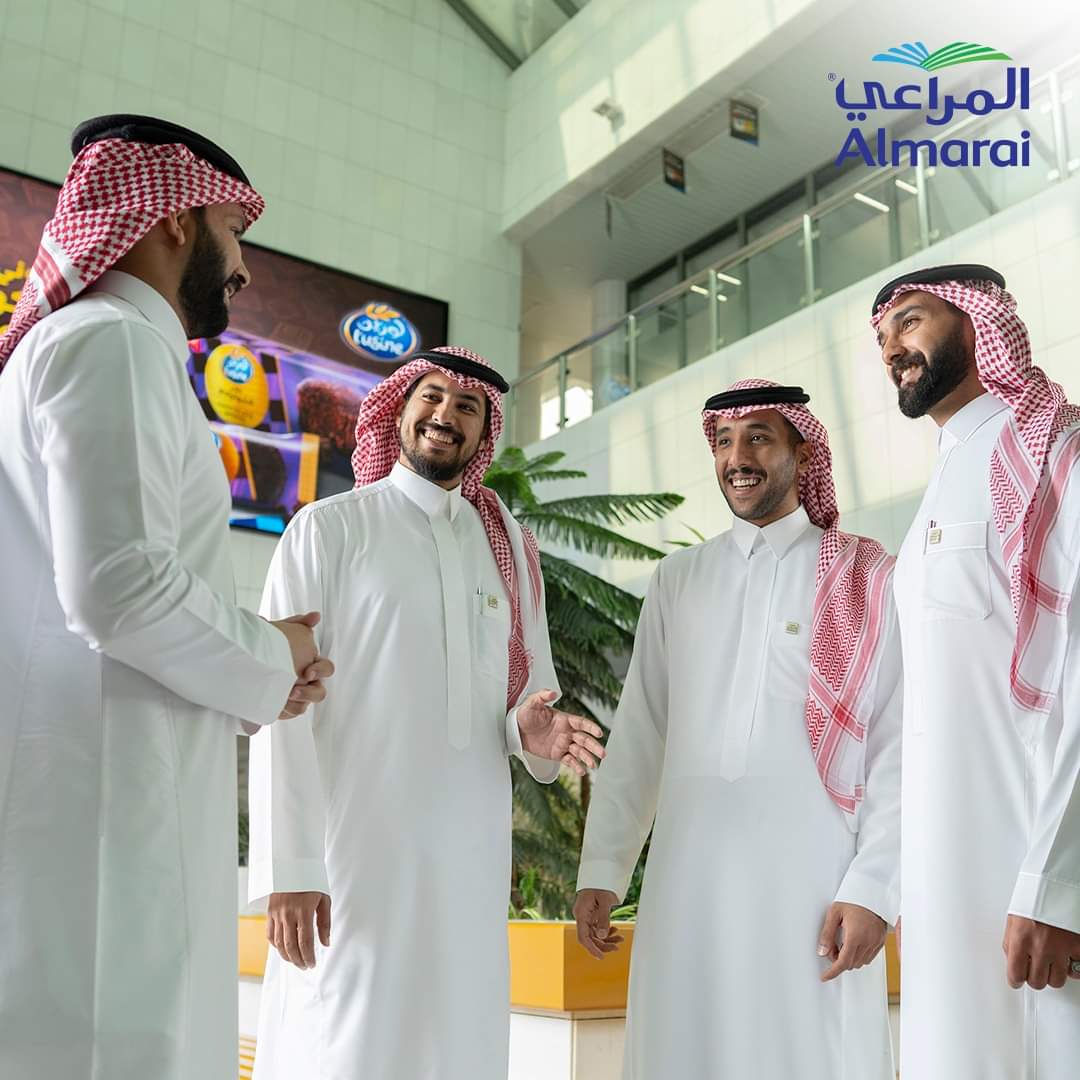 Woman holding passport and tickets, standing with a yellow suitcase.